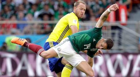 FILE - In this Wednesday, June 27, 2018 file photo Sweden's Andreas Granqvist, rear, and Mexico's Javier Hernandez, front, challenge for the ball during the group F match between Mexico and Sweden, at the 2018 soccer World Cup in the Yekaterinburg Arena in Yekaterinburg , Russia. FIFA has fined Sweden's soccer federation 70,000 Swiss francs ($70,750) for players wearing unapproved branded clothing. FIFA says the Sweden team defied requests "to cease the activity that led to the sanction." (AP Photo/Gregorio Borgia)