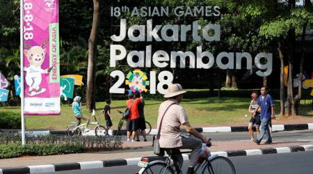 A cyclist rides past an installation promoting the upcoming Asian Games, to be held in Jakarta and Palembang, during the weekly car-free day in Jakarta, Indonesia July 15, 2018. REUTERS/Darren Whiteside