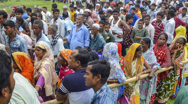 People wait to check their names on the final draft of the state's National Register of Citizens after it was released, at an NRC Seva Kendra in Tezpur on Monday. (PTI)