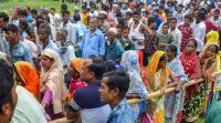 People wait to check their names on the final draft of the state's National Register of Citizens after it was released, at an NRC Seva Kendra in Tezpur on Monday. (PTI)