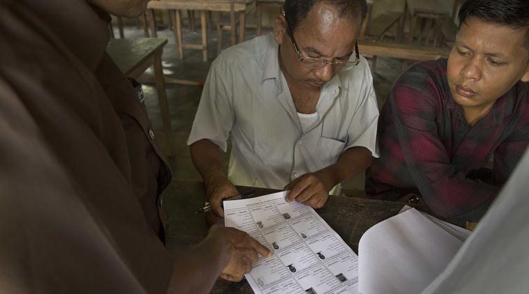 People check if their names are included in the NRC list at a draft center in Mayoung on Monday. (AP)
