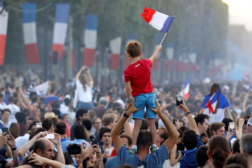 France fans celebrate on the Champs-Elysees avenue after France win