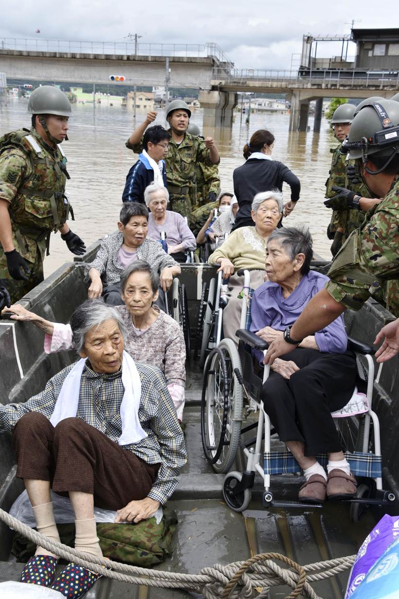 Flooding and landslides in Japan leave at least 100 dead