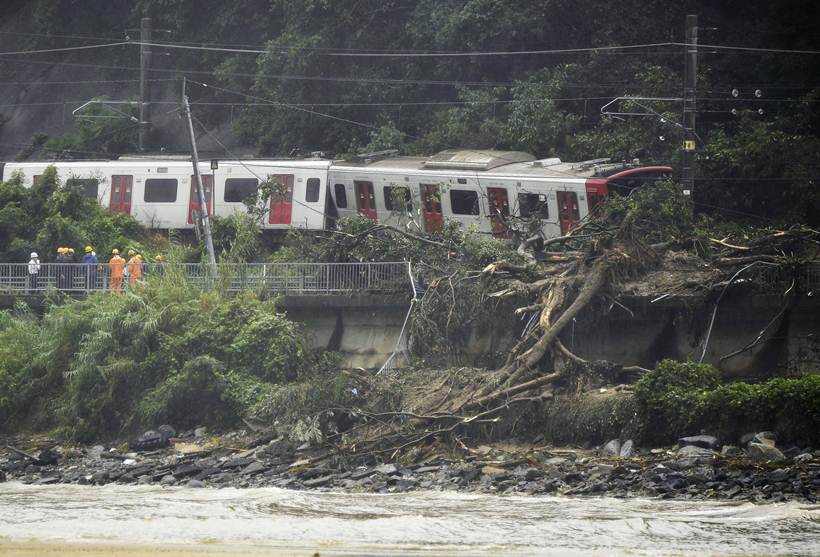 Flooding and landslides in Japan leave at least 100 dead