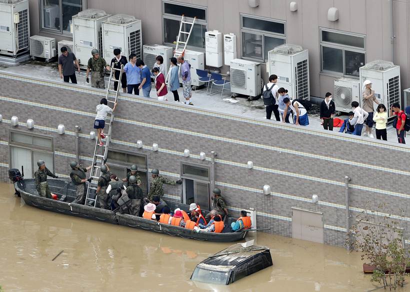 Flooding and landslides in Japan leave at least 100 dead