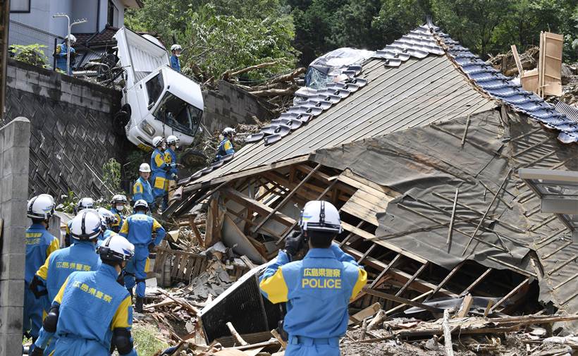 Flooding and landslides in Japan leave at least 100 dead
