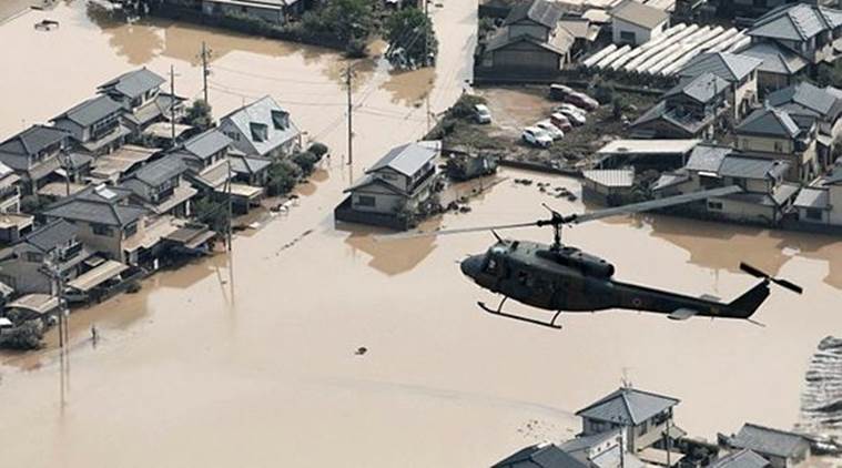 A helicopter flies over Mabi town which was flooded by the heavy rain in Kurashiki on Sunday. (Reuters)