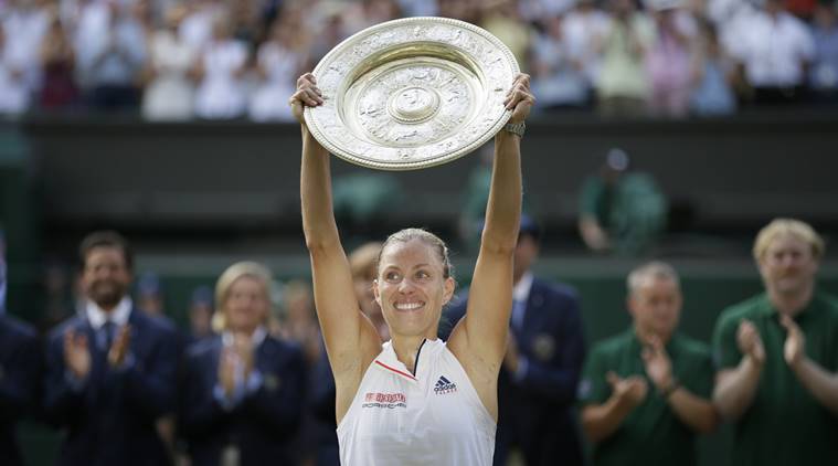 Germany's Angelique Kerber lifts the trophy after winning the women's singles final match against Serena Williams of the United States, at the Wimbledon Tennis Championships