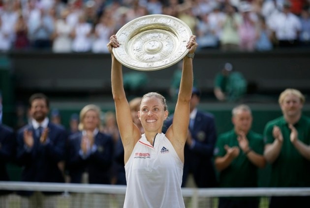 Germany's Angelique Kerber lifts the trophy after winning the women's singles final match against Serena Williams of the United States, at the Wimbledon Tennis Championships