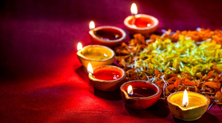 lighting diya for diwali