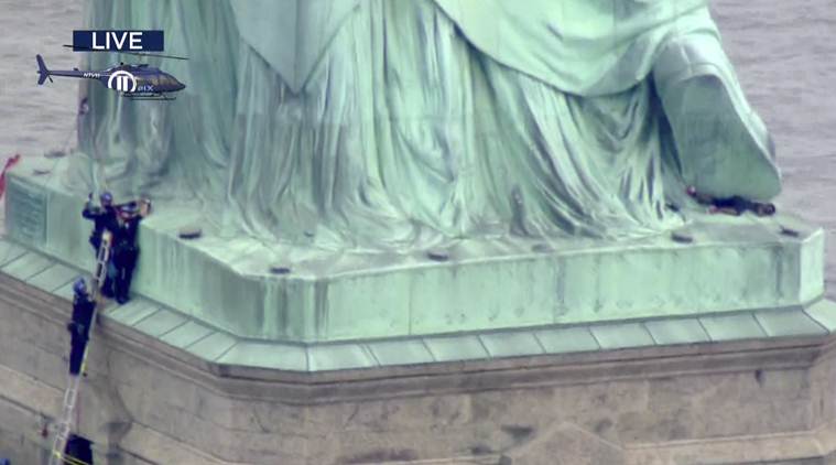 Protester scales Statue of Liberty's base, forces evacuation