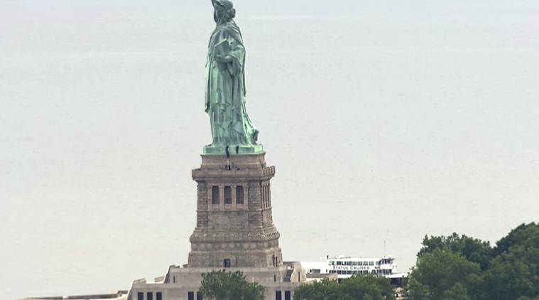 Protester scales Statue of Liberty's base, forces evacuation
