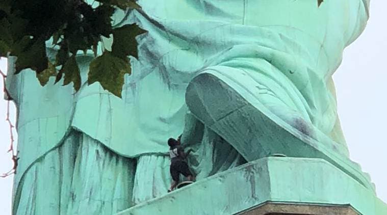 Protester scales Statue of Liberty's base, forces evacuation