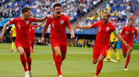 England's Harry Maguire, center, celebrates with his teammates after scoring his side opening goal during the quarterfinal match between Sweden and England at the 2018 soccer World Cup in the Samara Arena, in Samara, Russia, Saturday, July 7, 2018. (AP Photo/Francisco Seco)