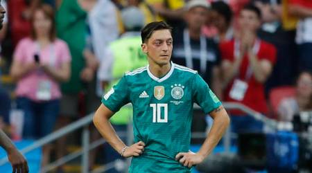 Germany's Mesut Ozil stands on the pitch after his team lose the group F match between South Korea and Germany, at the 2018 soccer World Cup in the Kazan Arena in Kazan, Russia, Wednesday, June 27, 2018. (AP Photo/Frank Augstein)
