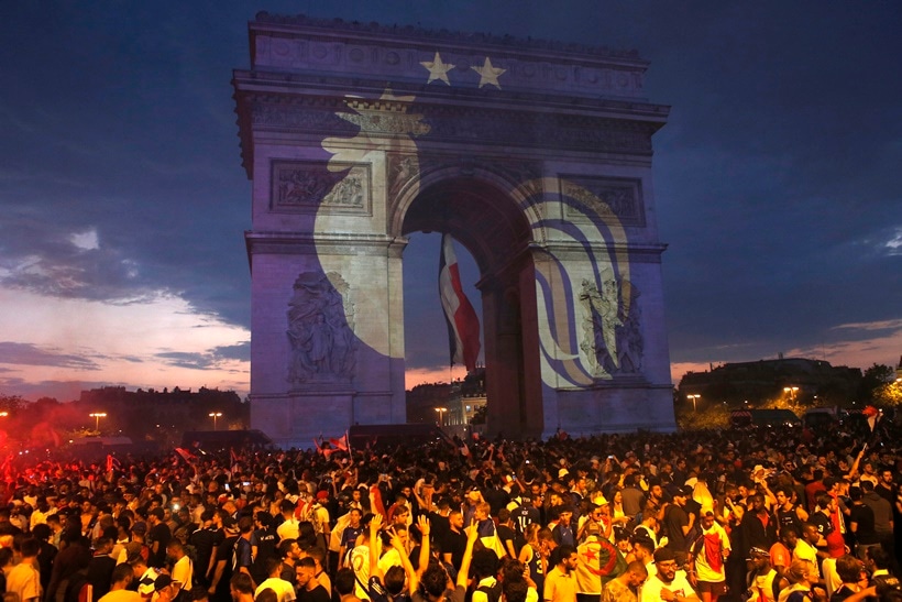 A rooster, a symbol of France, and two stars indicating two World Cup wins, are projected onto the Arc de Triomphe after France won the soccer World Cup final match between France and Croatia