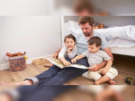 Father Reading Story To Children In Their Bedroom