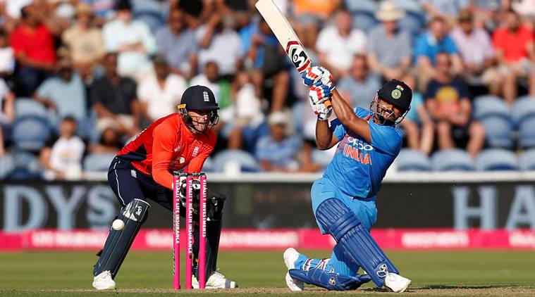 India's Suresh Raina in action as England's Jos Buttler looks on