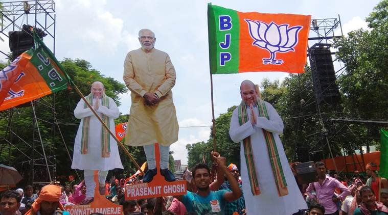 BJP supporters with cutouts of Prime Minister Narendra Modi and Amit Shah at the rally in Kolkata. (Express photo/Partha Paul)