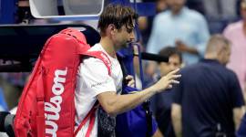 David Ferrer of Spain, leaves the court after retiring from his first-round match against Rafael Nadal, also of Spain, at the U.S. Open tennis tournament