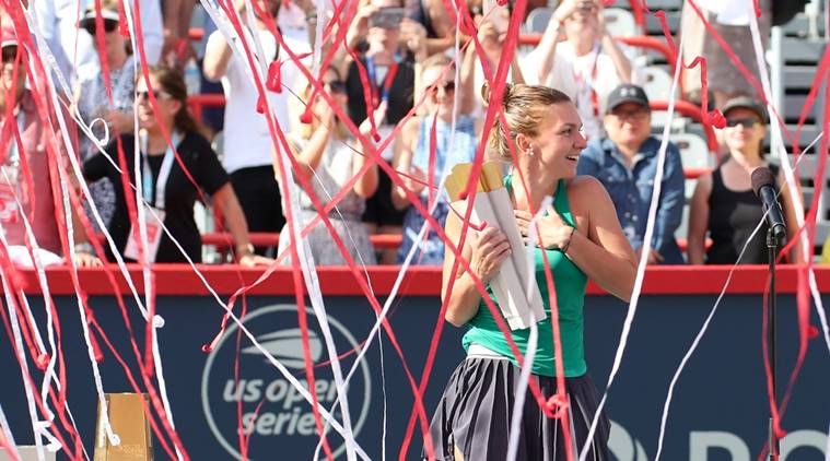 Confetti falls on Simona Halep of Romania as she win against Sloane Stephens of the United States (not pictured) during the Rogers Cup tennis tournament at Stade IGA.