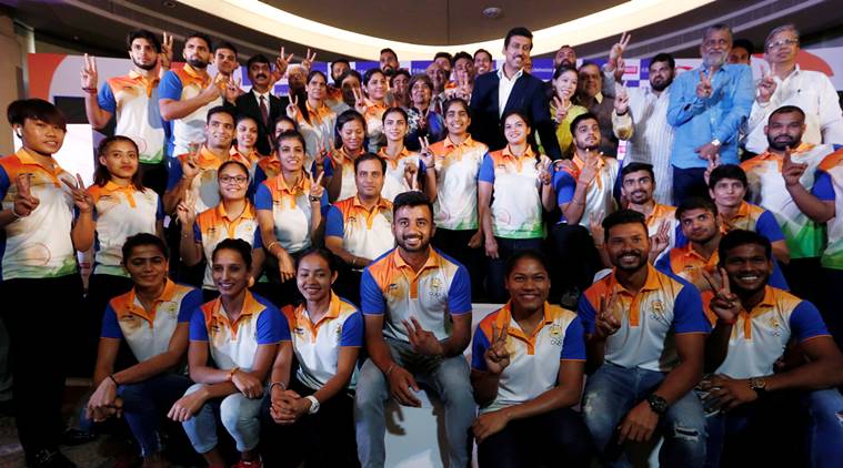 Members of India's Asian Games contingent with Sports Minister Rajyavardhan Singh Rathore.