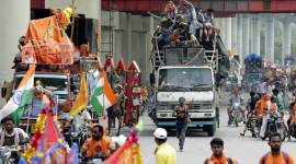 Kanwarias in Delhi. (Express photo by Praveen Khanna) It took more than 25 minutes for a dozen-odd kanwarias armed with baseball bats to overturn a Santro car, assault one of the occupants and bring traffic to a standstill — as three Police Control Room (PCR) officers tried to reason with them. But with their efforts in vain, and police realising the situation could escalate, Moti Nagar police station, barely 100 metres away, rushed five more officers to the spot — without riot gear. By the time they reached, the group, which had gone on a rampage after the Santro allegedly brushed past one of them, had disappeared. A day later, the men seem to be in the wind — and police at a loss for answers. While an FIR has been registered, it is only against "unknown persons". This, despite the incident being caught on video. According to an officer, the fact that thousands of kanwarias took the route on Tuesday has made it difficult for police to narrow down the group. For now, police said they are contacting rest shelters along the route for information about the accused. An officer said they are looking at the CCTV footage to pull out photographs that can be used to identify the men. “Of course it will be difficult to ascertain their identity. But we are confident of tracing them,” said Deputy Commissioner of Police (West) Vijay Singh. “During inquiry conducted by an ACP-rank officer, it came to the notice that one of the kanwarias was slapped by the woman, which further agitated them.” In fact, the kanwarias were not supposed to be on this stretch in the first place. But with the dedicated corridor meant for their movement waterlogged, the men took an alternative route, police said. “We had made a special corridor for them to pass through. But due to heavy rain, the makeshift route had been filled with water and they were forced to walk on the main road,” Singh said. On Wednesday, barricades had come up to ensure kanwarias had a dedicated path. Eyewitnesses have claimed that it took police over 20 minutes to send back-up to help the three PCR staffers who first reached the spot, though police maintain it was about 10 minutes. "The kanwarias started smashing the windows of the car with their bare hands. Some of them had blocked traffic by placing several pitchers, ostensibly filled with Ganga jal. They gathered within minutes, destroyed the car, and even took selfies as the two officers watched," claimed Abhishek Sharma, an eyewitness. Local police claimed they did not send men with riot gear as that could have escalated the situation. The occupants of the car — the woman who was driving and her friend who was roughed up — had opted not to file a complaint. This prompted police to register an FIR on their own — under IPC sections 427 (mischief causing damage to the amount of fifty rupees), 341 (punishment for wrongful restraint) and 34 (common intention). The woman behind the wheel, daughter of an Army officer, could not be contacted for a comment.