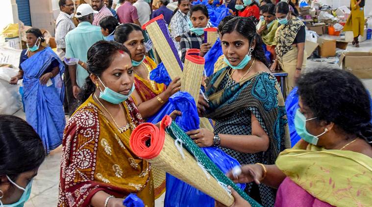 People segregate flood relief material received at a distribution centre, in Kochi on Wednesday. (PTI)