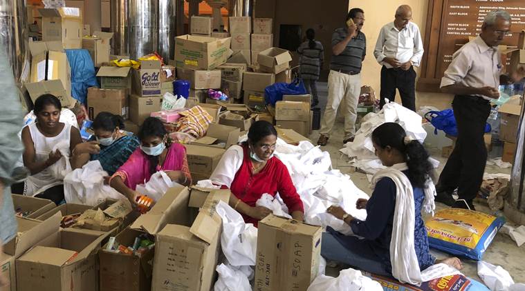 Judges and lawyers prepare relief material for flood affected people at the Kerala High Court premises in Kochi. (AP)