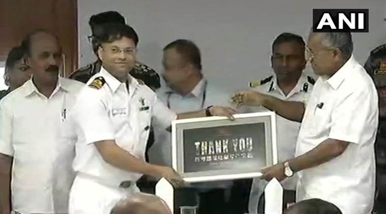 Kerala Chief Minister Pinarayi Vijayan thanks a Naval officer in Thirvananthapuram on Sunday. (ANI)
