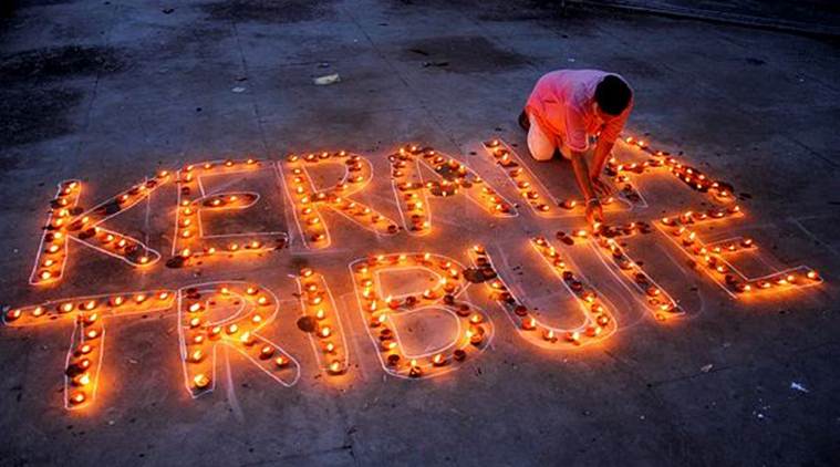 A man lights lamps to pay tribute to Kerala flood victims, in Amritsar on Tuesday. (PTI)