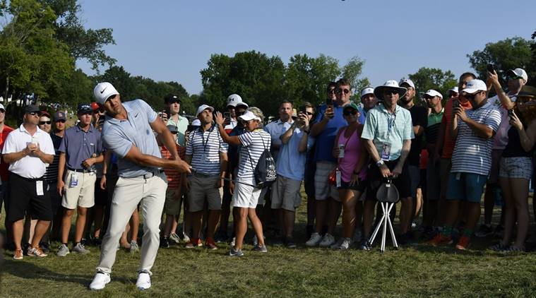 Brooks Koepka hits out of the rough on the 15th hole during the third round of the PGA Championship golf tournament at Bellerive Country Club.
