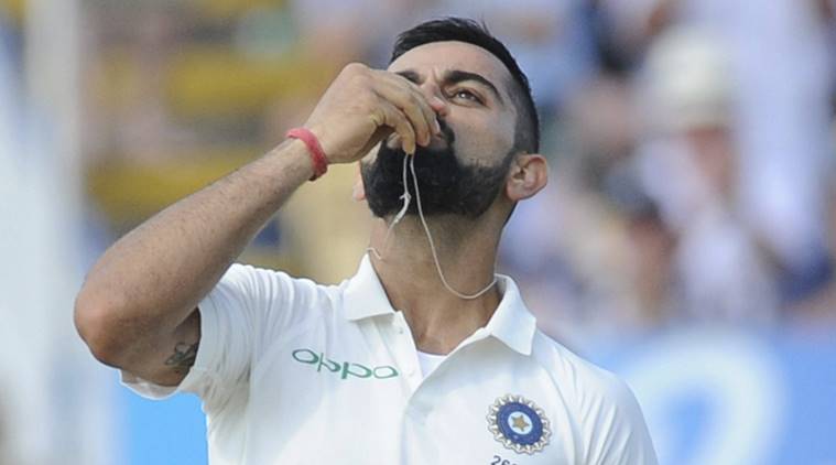 Indian cricket captain Virat Kohli celebrates after scoring a century during the second day of the first test cricket match between England and India at Edgbaston in Birmingham