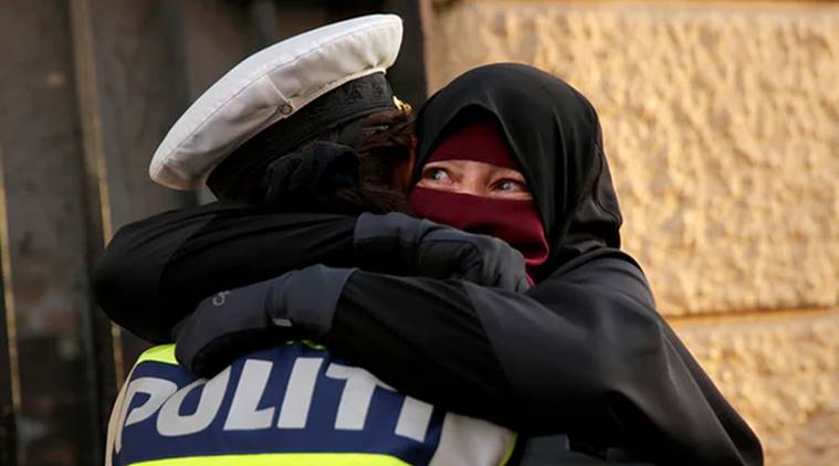 Denmark face veil ban, Denmark protests, Danish policewoman viral photo, cop hugging viral photo, cop hugging veil woman, indian express, indian express news