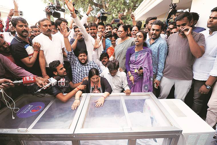 Kalpana, wife of Apple executive Vivek Tiwari weeps over his body at their home in Lucknow Saturday. Vishal Srivastav