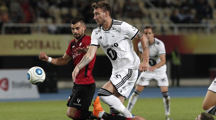 Rosenborg's Nicklas Bendtner, center, challenges with Shkendija's Egzon Bejtullai, left, during the Europa League play-off, second leg soccer match between Shkendija and Rosenborg, at Philip II Arena in Skopje, Macedonia