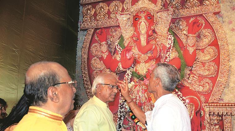 Ministers Sadhan Pande (left) and Sovandeb Chattopadhyay during Ganesh puja at Pande’s home. (Express photo)