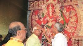 Ministers Sadhan Pande (left) and Sovandeb Chattopadhyay during Ganesh puja at Pande’s home. (Express photo)