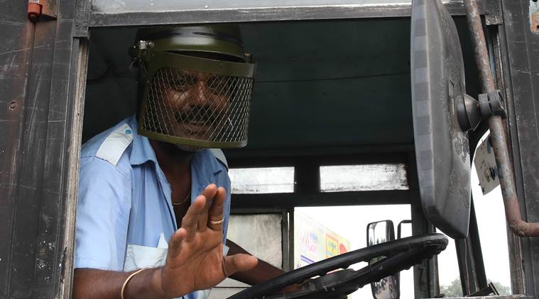 A bus driver wears a helmet to protect himself from stone pelters in Kolkata. (Express photo/Partha Paul)