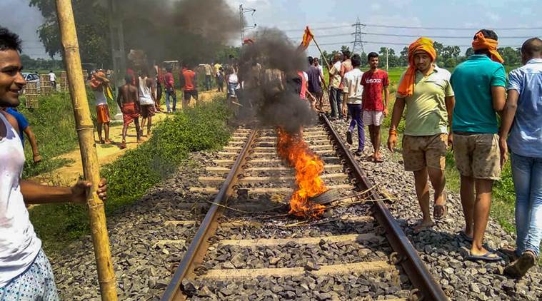 Swarn Sena activist burn tyres on the railway tracks to stop trains during their Bharat bandh, called to press for reservation, in Patna, Thursday, Sept 6, 2018. (PTI Photo)