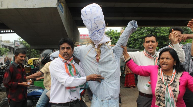 Congress workers protest along with an effigy in Ahmedabad on Monday. (Express photo/Javed Raja)