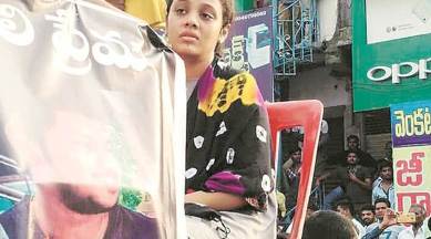 Pranay’s wife Amrita Varshini sits beside his coffin, at the funeral procession in Miryalaguda town. (Express photo)
