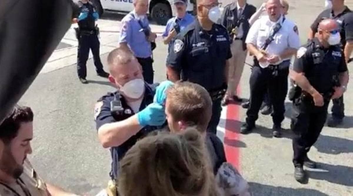 Passengers are assisted by the air cabin crew and the emergency services on a flight from New York to Dubai, at JFK Airport, New York, on Wednesday. (Reuters)