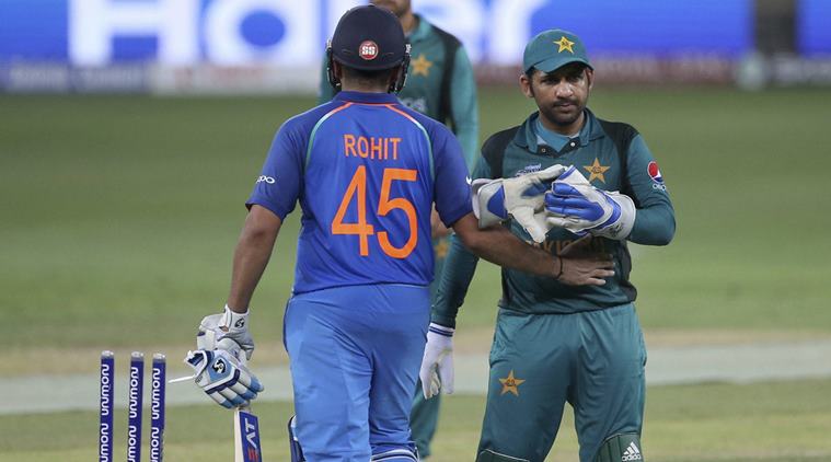 India's captain Rohit Sharma, left, greets Pakistan's captain Sarfraz Ahmed as they leave the field at the end of the one day international cricket match of Asia Cup between India and Pakistan in Dubai