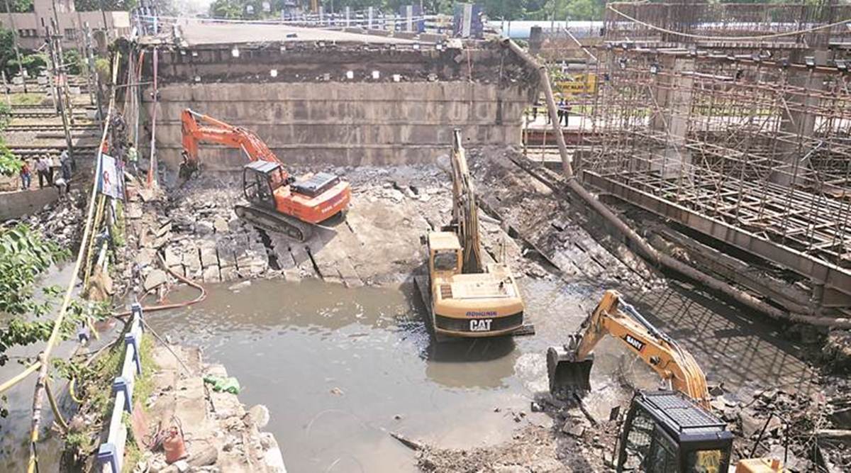 Cleaning work continues at the Majherhat bridge on Saturday. (Express photo/Subham Dutta)