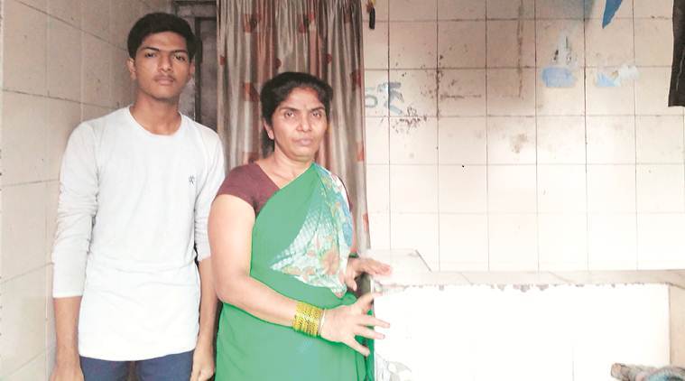 Raju Sawant's wife Sharada with her son at the Sinhagad Road lavatory. (Express photo)