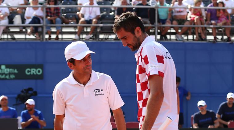 Croatia's Marin Cilic speaks with umpire Carlos Ramos during his match against Frances Tiafoe of the U.S.
