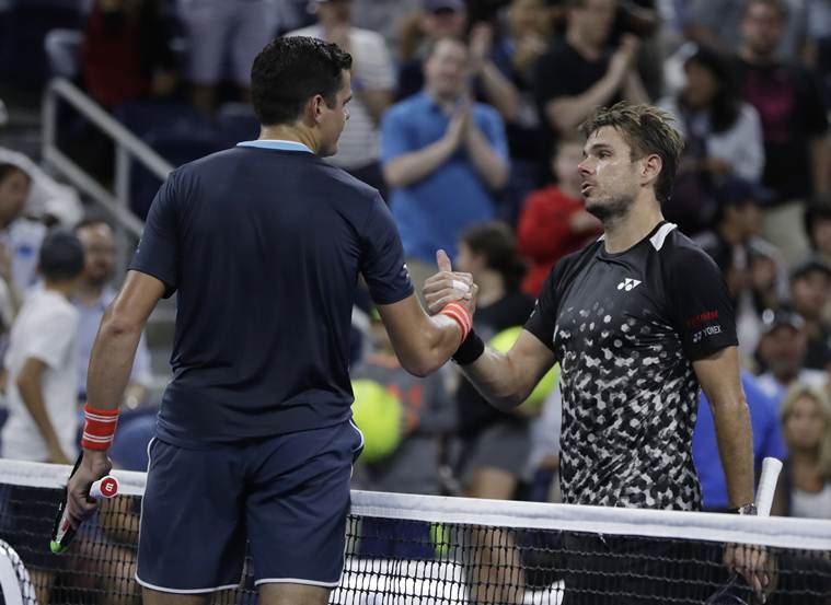 Milos Raonic, left, of Canada, shakes hands with Stan Wawrinka, of Switzerland, after Raonic won their third-round match at the U.S. Open tennis tournament, Friday, Aug. 31, 2018, in New York.