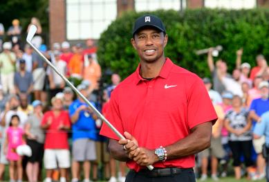 Tiger Woods holds Calamity Jane the official trophy of the tournament after winning the Tour Championship golf tournament in Atlanta.