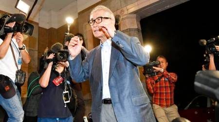 Tasuku Honjo of Kyoto University heads to the venue for a press conference in Kyoto, western Japan Monday, Oct. 1, 2018. The Nobel Prize in medicine was awarded Monday to Honjo and James Allison of the University of Texas Austin. (Ren Onuma/Kyodo News via AP)